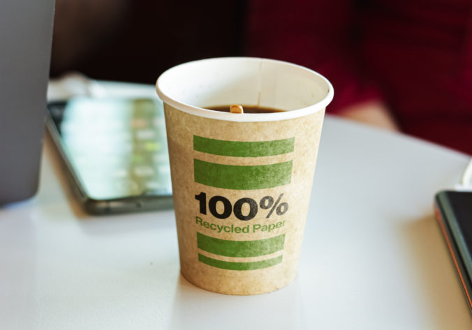 A recycled paper container containing hot coffee for a break.