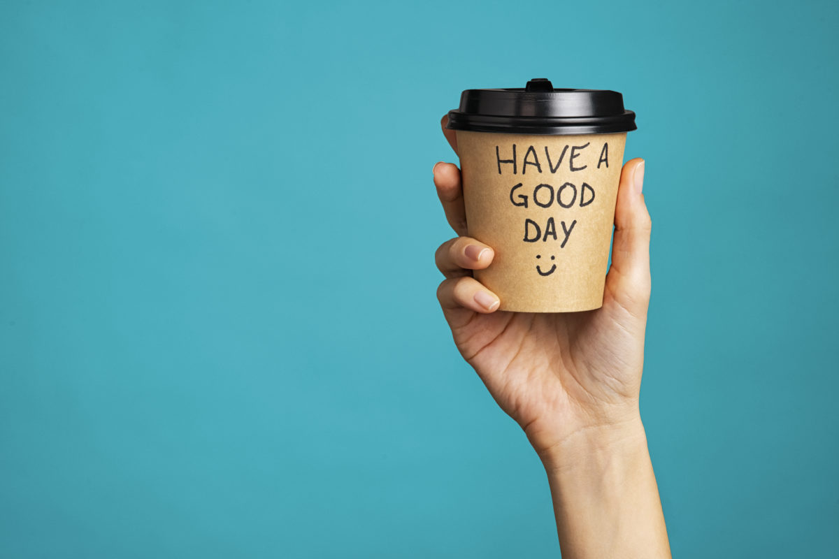 Woman holding morning coffee cup