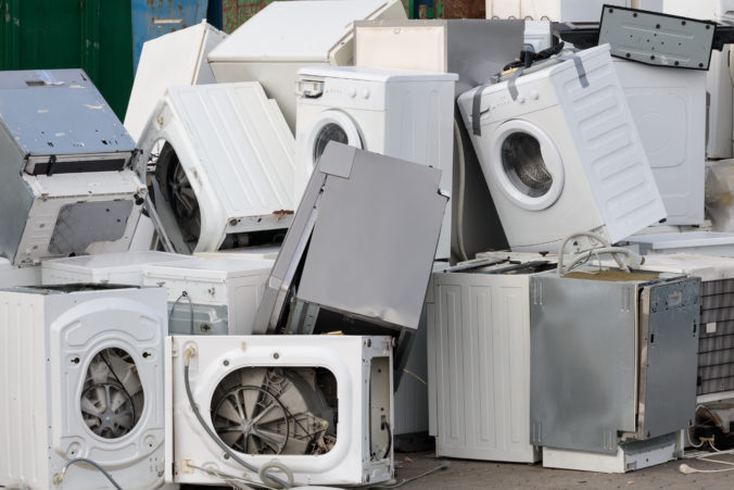 Electronic equipment in a landfill. Pile of used household appliances, close up.