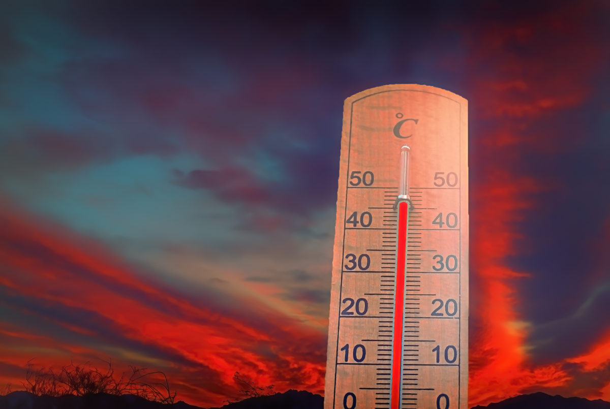 Thermometer on background of abnormally colored clouds.