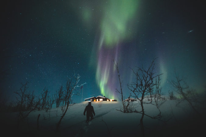 Man and Northern Lights over Riksgransen, Sweden