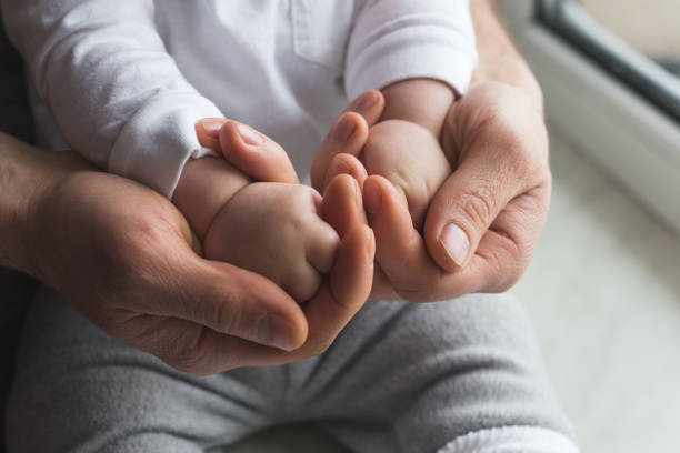 Father holding child hands