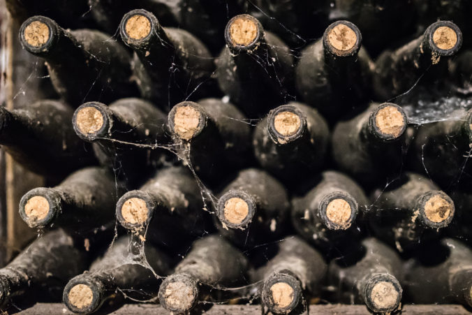Old wine bottles covered with dust and cobwebs