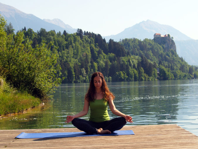 Woman Practicing Yoga on Pier Overlooking Lake Bled