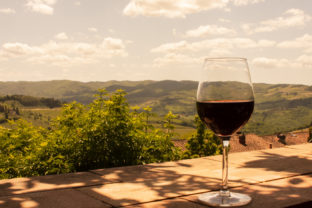 Glass of red wine on the hills of Tuscany in Italy.
