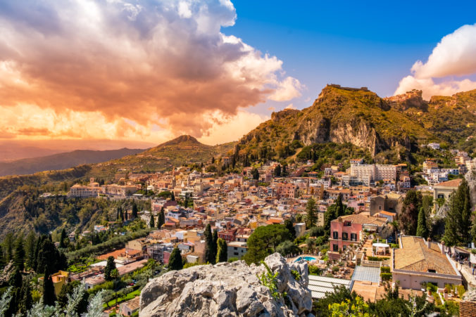 Taormina, Sicily, Italy. Panoramic view over Taormina old town and mountains in background. Popular tourist destination on Sicily