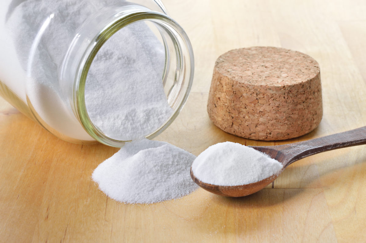 Close up of baking soda in a glass jar.