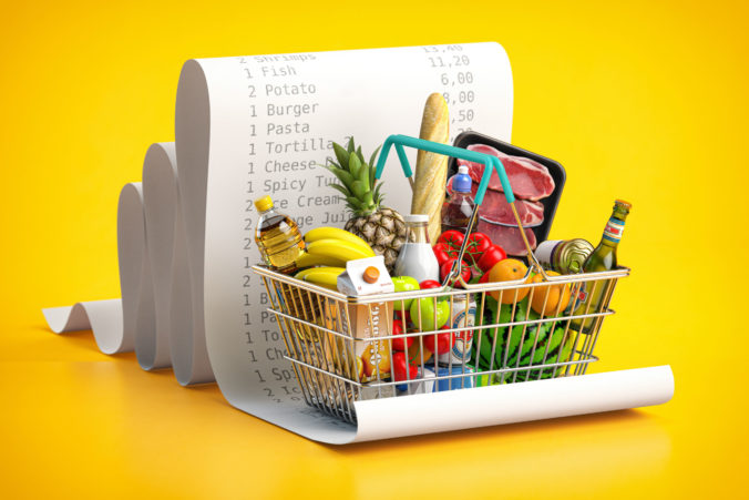 Shopping basket with foods on receipt. Grocery expenses budget,