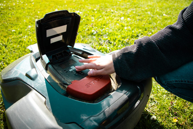 Woman Setup Automatic Robotic Lawn Mower