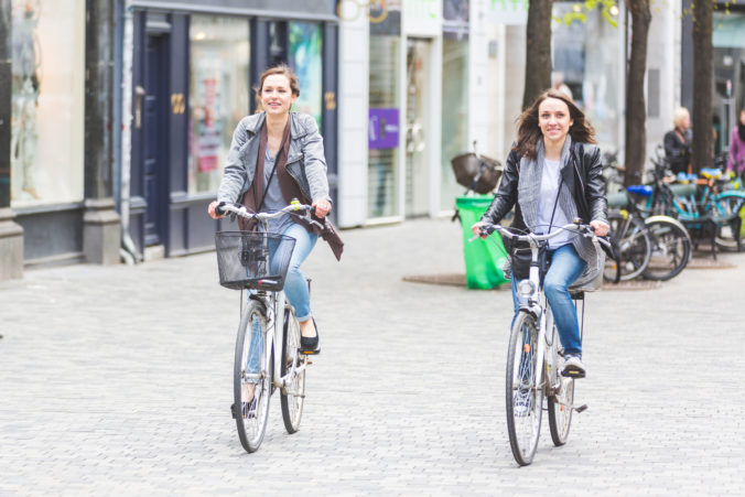 Two women going by bike in Copenhagen.