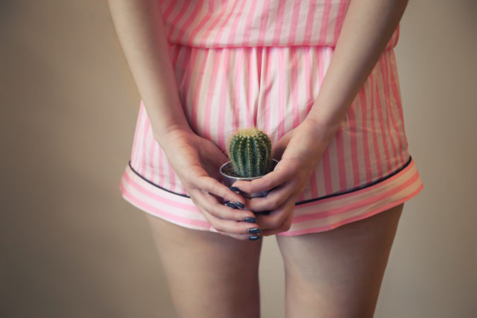 A girl in pajamas holds a cactus near the priests. Hemorrhoids, stool problems, bowel problems. postpartum hemorrhoids