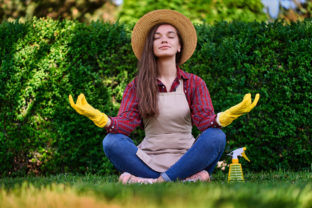 Calm,Woman,Gardener,In,A,Straw,Hat,,Apron,And,Yellow