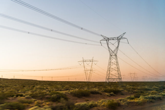 Electricity power tower line pylons at the sunrise. Concept of energy, connectivity, industry, infrastructure, and technology