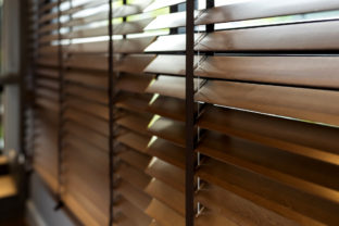 Wooden window shutter blind with light from sun home interior concept