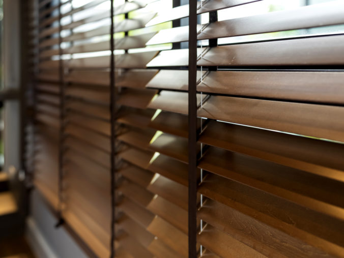 Wooden window shutter blind with light from sun home interior concept