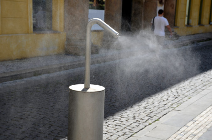 Park air freshener with micro drip sprayer made of stainless steel in a public park in the hot summer will relieve runners who will refresh themselves here. children have fun here run through water