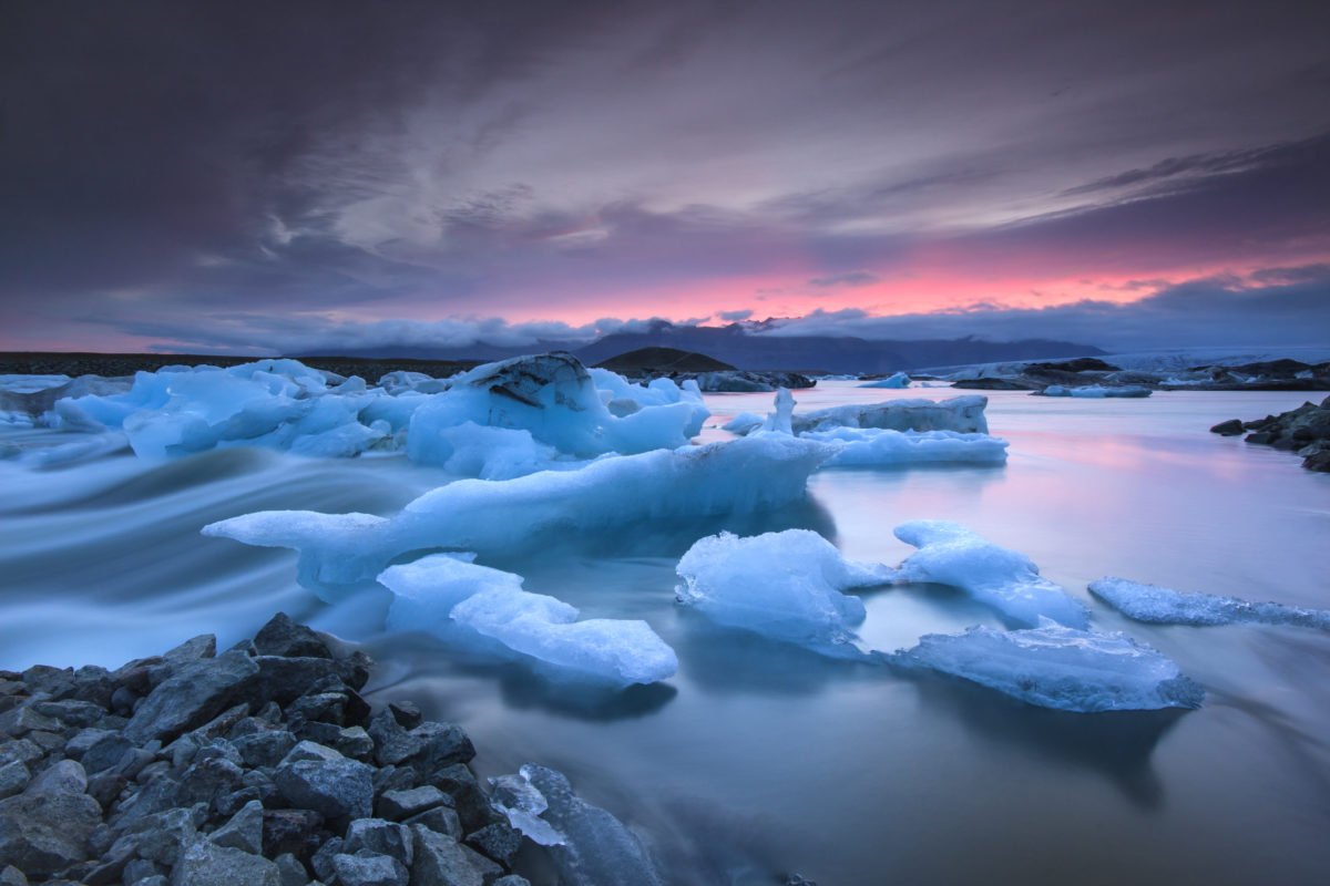 Icebergs floating in Jokulsarlon glacier lake at sunset