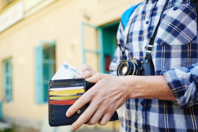 Young Man Saving Money for Traveling