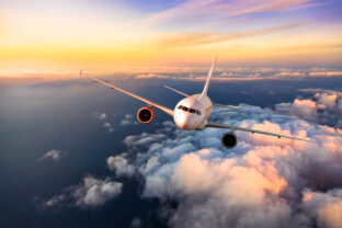 Passengers commercial airplane flying above clouds