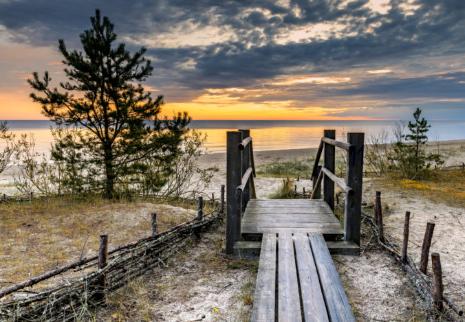 Sunrise on sandy beach of the Baltic Sea in Jurmala