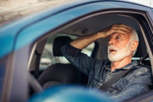 Angry man in the car yells at the driver in front.