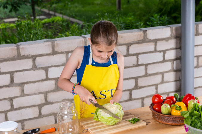 Young girl preparing a fresh cabbage