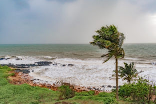 Climate change photo, taken during high speed cyclonic winds gushing through the coastal region, with heavy downpour taking place at horizon due to which it looks milky, and rain approaching coast.