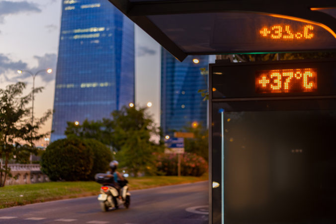 Street thermometer in screen sign displays 37 degrees Celsius at sunset in Madrid. Hot summer. Heat wave and climate change