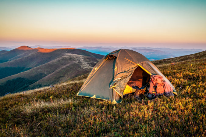 Tourist tent in Mountains at beautiful sunrise