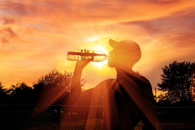 Man drinking water during heat wave