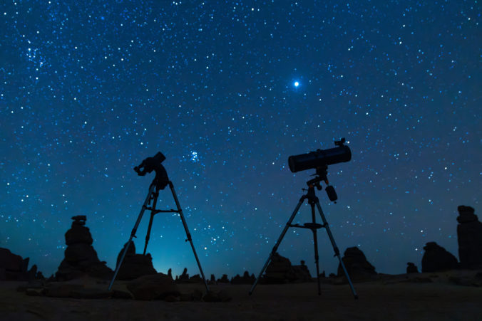 Astronomer with a telescope watching at the stars and Moon. My astronomy work