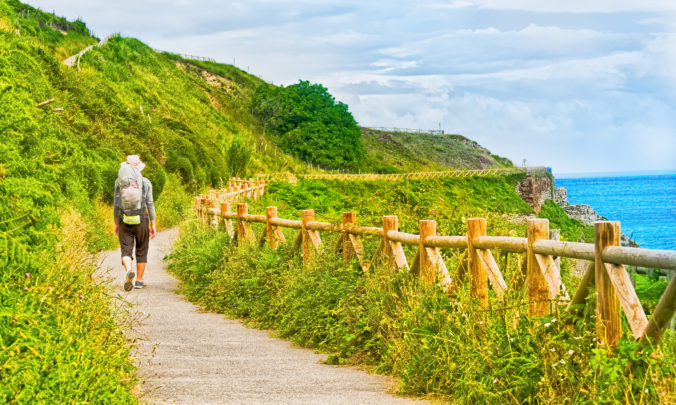 Lonely Pilgrim with backpack walking the Camino de Santiago in Spain, Way of St James