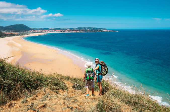 Mother with son tourists on the Atlantic ocean seaside