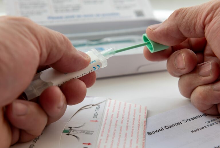 London. UK  04.17.2024. A person putting the bowel cancer test sample in the sample holder before sending it off by mail for testing.