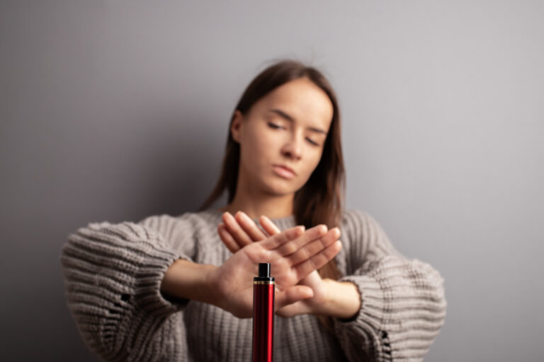 Quit vape smoking teenager, teen girl refuses disposable cigarette