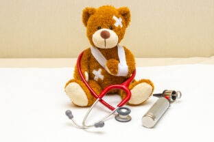 Teddy bear with bandages in pediatrician's office