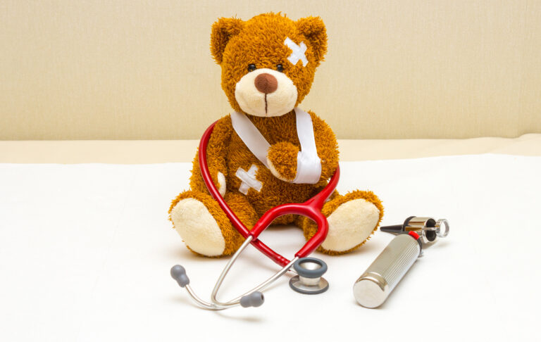 Teddy bear with bandages in pediatrician's office