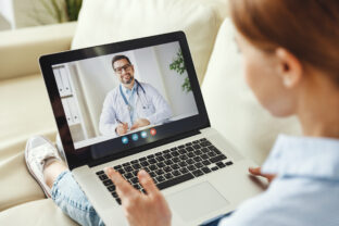 Woman using tablet to speak with doctor