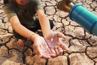 Asian girl rural sitting on dry ground. Water crisis, Concept hope and drought.