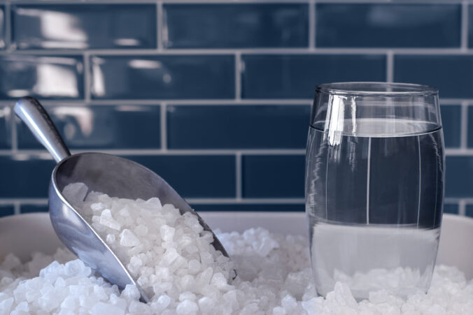 Glass of water and water softener salt