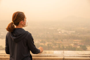 Asian woman wearing an N95 mask for protect bad air pollution.