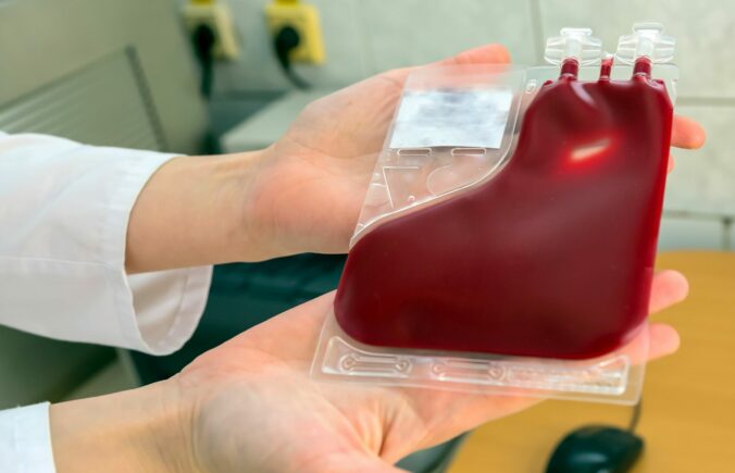 Placental cord blood bank donated blood unit prepared by gloved hands isolated.