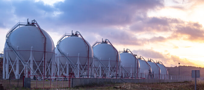 Gas storage tanks at sunset.