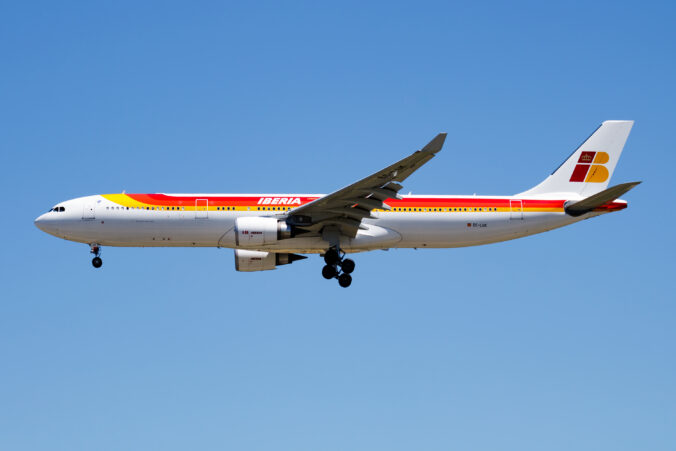 Iberia Airlines passenger plane at airport. Schedule flight travel. Aviation and aircraft. Air transport. Global international transportation. Fly and flying.