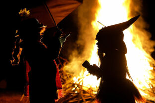 Children in Halloween Costumes Stand Near Bon Fire