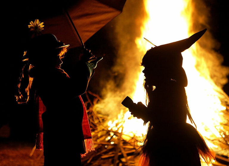 Children in Halloween Costumes Stand Near Bon Fire