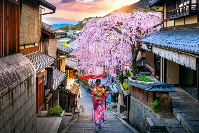 Woman wearing japanese traditional kimono walking at Historic Higashiyama district in spring, Kyoto in Japan.