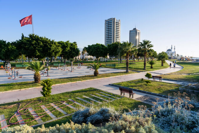 Hilton hotel in embankment of Iskenderun city which is located on the eastern Mediterranean coast on the Gulf of Iskenderun with turkish waving flag