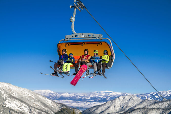 Skiers sitting onski lift chair in ski resort Jasna, Slovakia