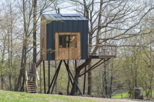 Modern wooden tree house in the forest. The treehouse was built as a retreat for holidaymakers wanting to get away from the hustle and bustle of the city.